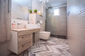 A modern bathroom with a wooden vanity, a sink, a toilet, and a shower area. - Luxury Villa POCRNJA with private heated pool, jacuzzi, sauna and pool table (Stanici)