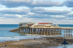 A pier extending into the sea with a pavilion theatre at the end. - The Heydon, Roughton, Norfolk (Roughton)