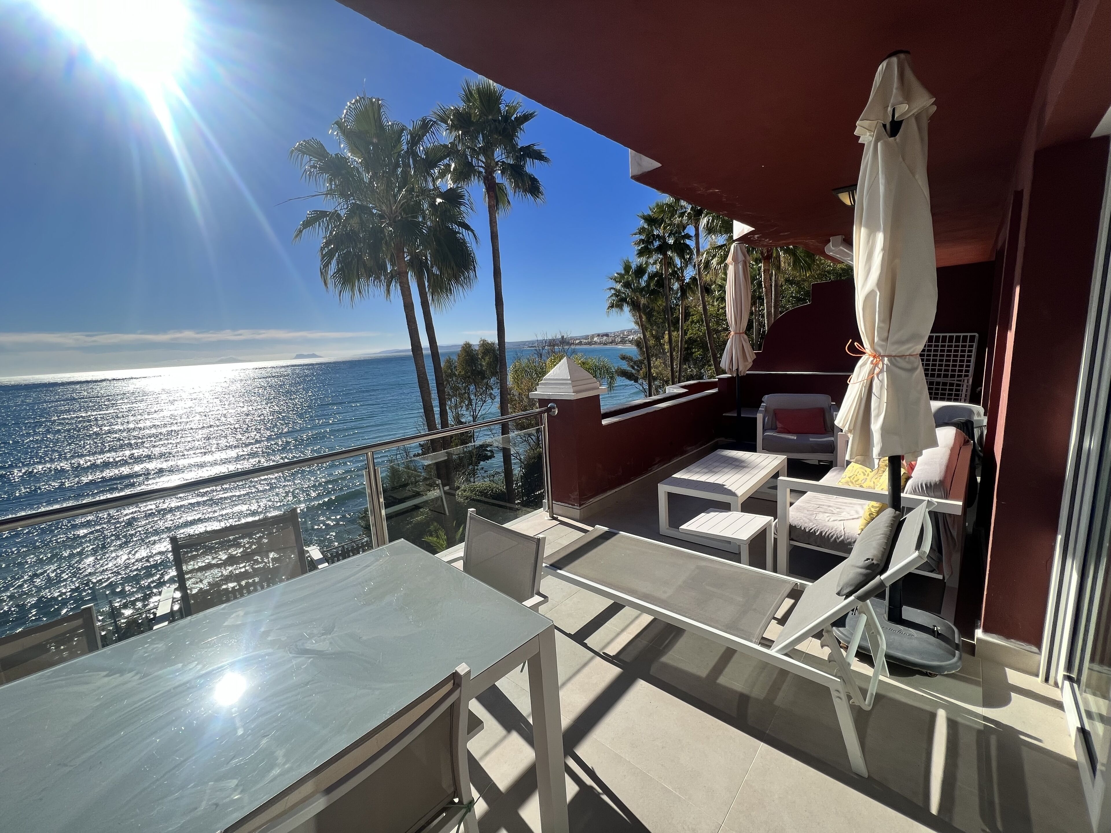 Balcony with seating area and table.