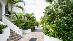 A stone pathway leading to a white building with a staircase. - 3 bedroom apartment with sunny terrace perfect for families (Costa Adeje)