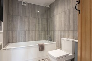 Bathtub, hair dryer, towels, soap