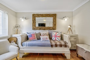 A bedroom with a bed, a dresser, a chair, and a mirror. - Lumiere - West Wittering (West Wittering, West Sussex)