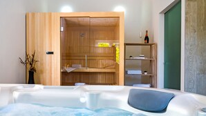 A spa area with a hot tub, wooden cabinets, and a bottle of champagne. - Lux villa,  heated infinity salt water pool, sauna, whirpool, close to the sea. (Smolonje)