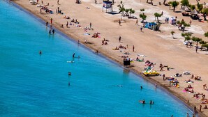 An aerial view of a beach with people swimming and sunbathing. - Lux villa,  heated infinity salt water pool, sauna, whirpool, close to the sea. (Smolonje)