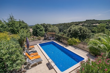 Loungers around the pool - view of vineyards to the coastline