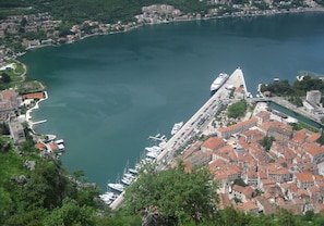 A coastal town with a marina, historic buildings, and a prominent church. - Beautiful apartment with pool and sea view of Kotor  (Muo)