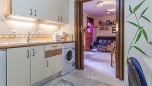 A kitchen with a washing machine, cabinets, and a countertop. - Sevilla best location apartment (Sevilla)