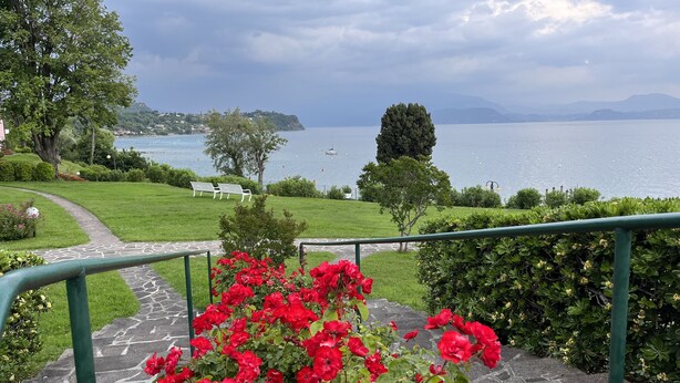 A stone pathway leading to a scenic overlook with a view of a lake and distant mountains. - Direct Lake Access: Panoramic Pool, Jetty & Parking (manerba del garda)