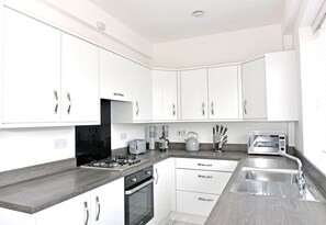 Fridge, microwave, oven, stovetop - Well presented three-bedroom property in great central location with balcony (Eastbourne)