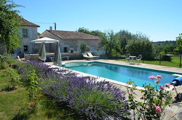 View of the farmhouse and converted barn with swimming pool.