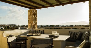 Relax on the terrace with a stone pillar, table, and comfortable sofa, perfect for a game of chess or a moment of contemplation.