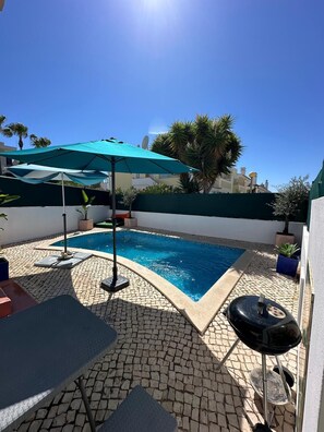 A swimming pool with a tiled deck, a grill, and an umbrella. - Villa with Private Pool And Sea Views. Less than 10 mins walk to Amenities&Beach (Ferragudo)