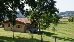 A house with a tiled roof, surrounded by a grassy field and trees. - Peaceful Gite + PRIVATE Pool Exclusively for you +Magnificent Panoramic Views  (Lalanne)