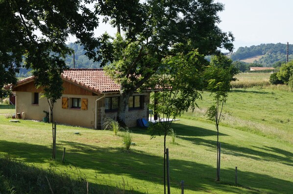 A house with a tiled roof, surrounded by a grassy field and trees. - Peaceful Gite + PRIVATE Pool Exclusively for you +Magnificent Panoramic Views (Lalanne)