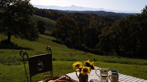 A table set outdoors with a view of a hilly landscape. - Peaceful Gite + PRIVATE Pool Exclusively for you +Magnificent Panoramic Views  (Lalanne)