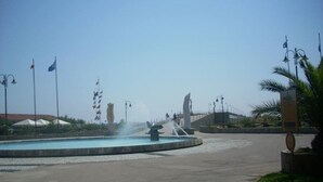 A public square with a fountain, flags, and a statue. - Pretty Independent Villa free wi-fi 2 bicycles (Pietrasanta)