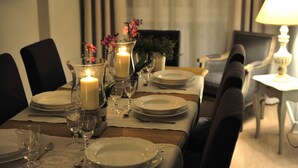 A dining table set for a meal with candles, glasses, and plates. - 6 bedrooms, 3 bathrooms, 1 kitchen, 1 dining room, 5 minutes walk to the Vatican (Roma)