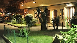 A hotel with a well-maintained garden, a fenced parking area, and a building entrance with a sign. - 6 bedrooms, 3 bathrooms, 1 kitchen, 1 dining room, 5 minutes walk to the Vatican (Roma)