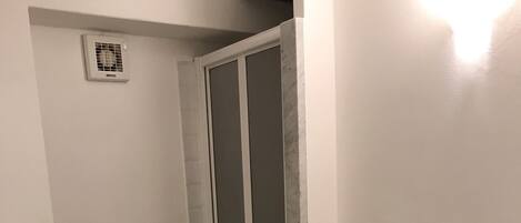 Een badkamer met toilet, bidet en douchecabine.