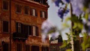 A multi-story building with a weathered facade, multiple windows with shutters, and balconies. - Rome: Luxury Apartment restructured in the heart of Rome (Roma)