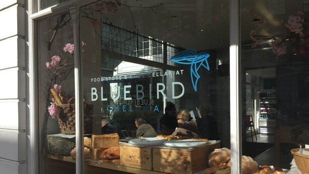 A bakery window display with various baked goods and a neon sign. - Splendid, light and spacious apartment between Fulham and Kings Rd Chelsea. (London)