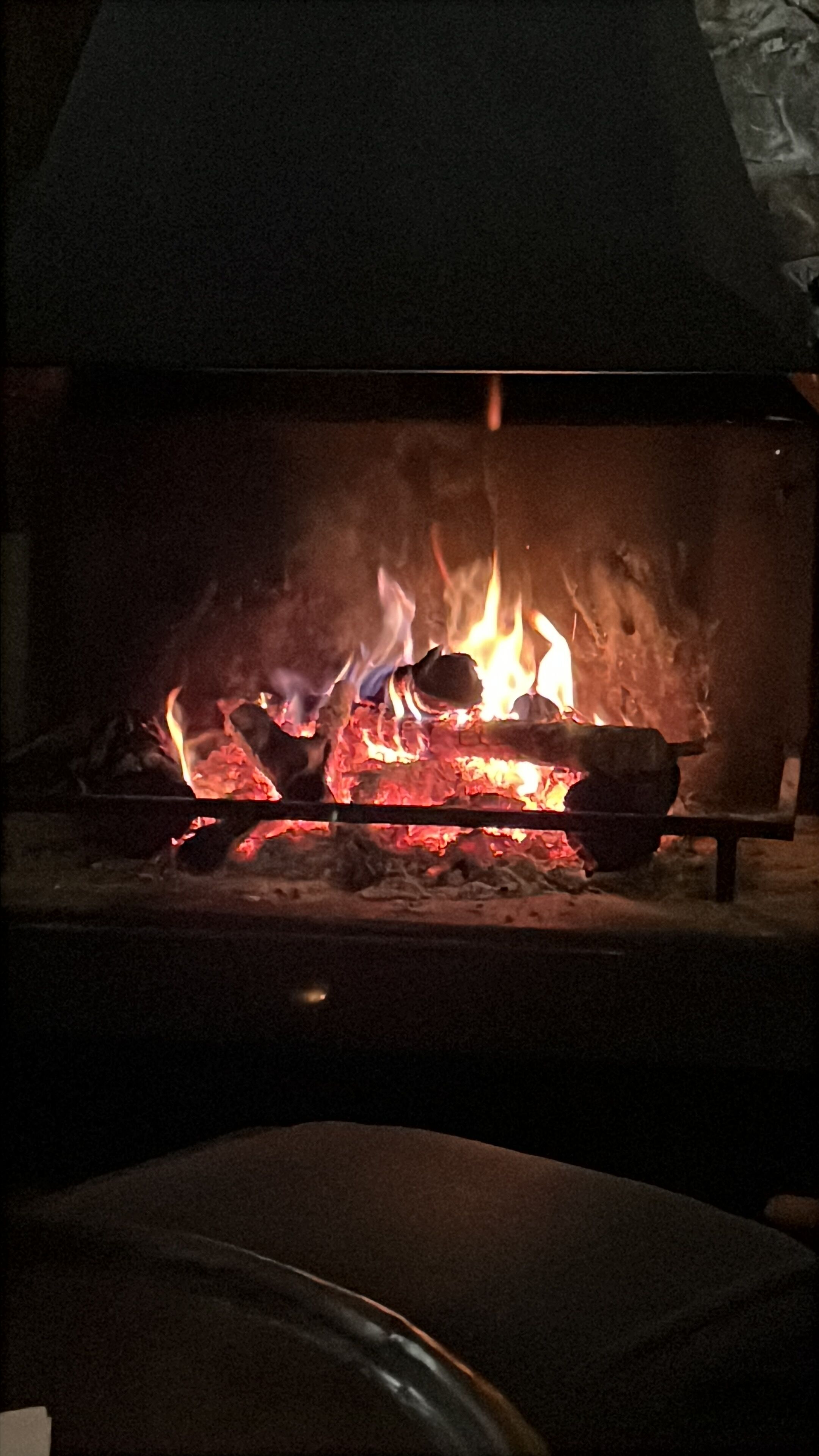 A fireplace with a fire burning inside.