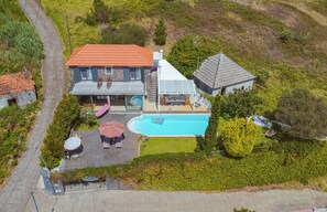 A residential property with a swimming pool, a patio area, and a stone building. - Special offer: House w / pool set in a romantic and idyllic location. (Prazeres - Calheta)