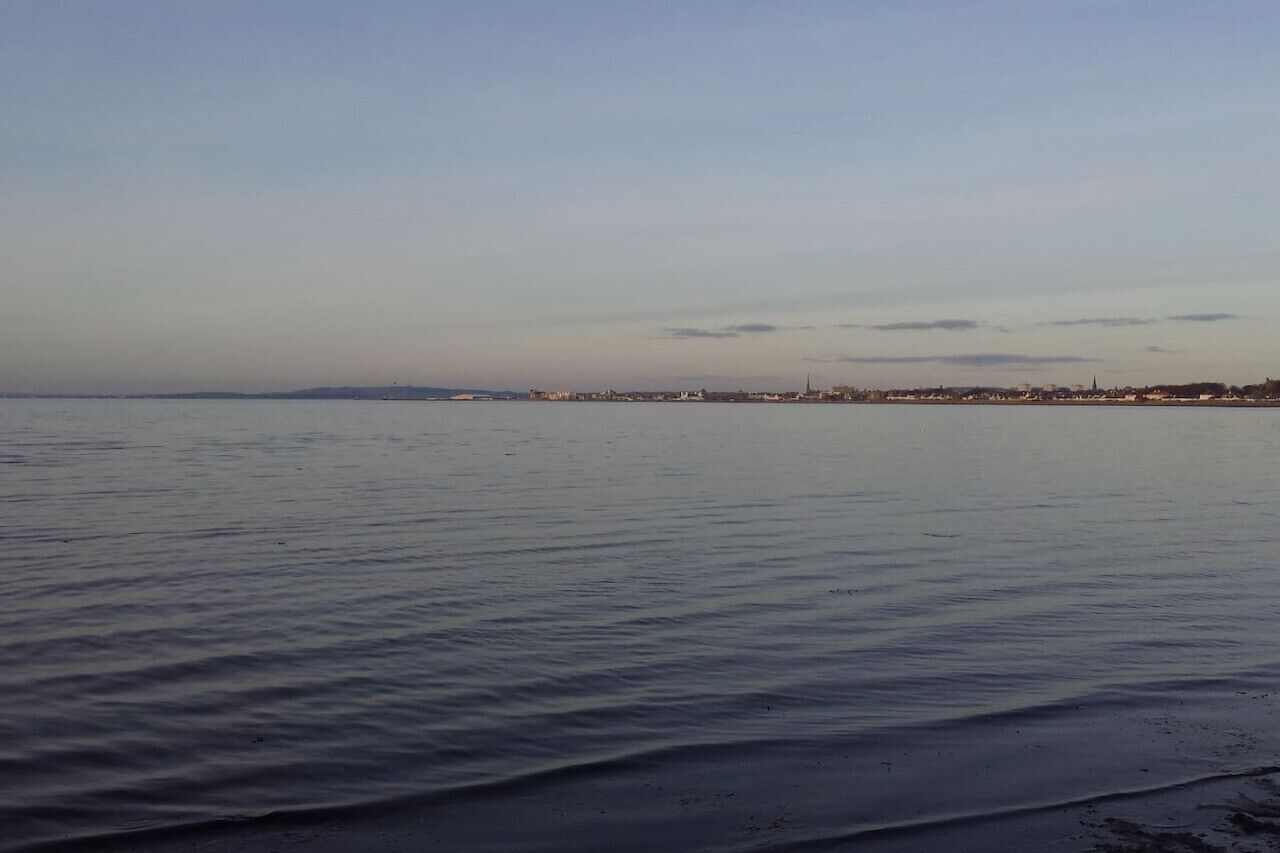 A calm body of water with a distant shoreline.