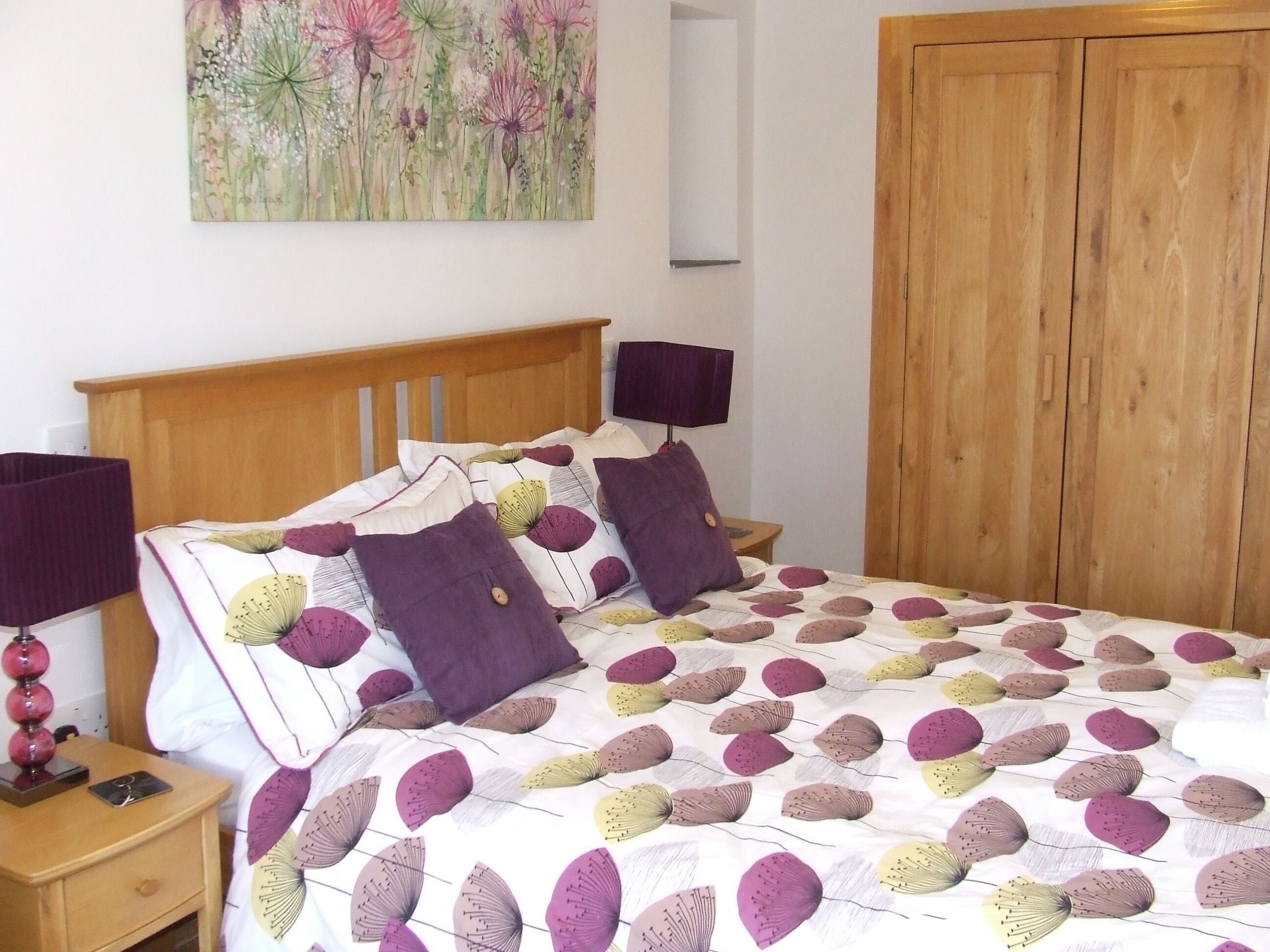 Bedroom 2, the purple bedroom, with a king size bed