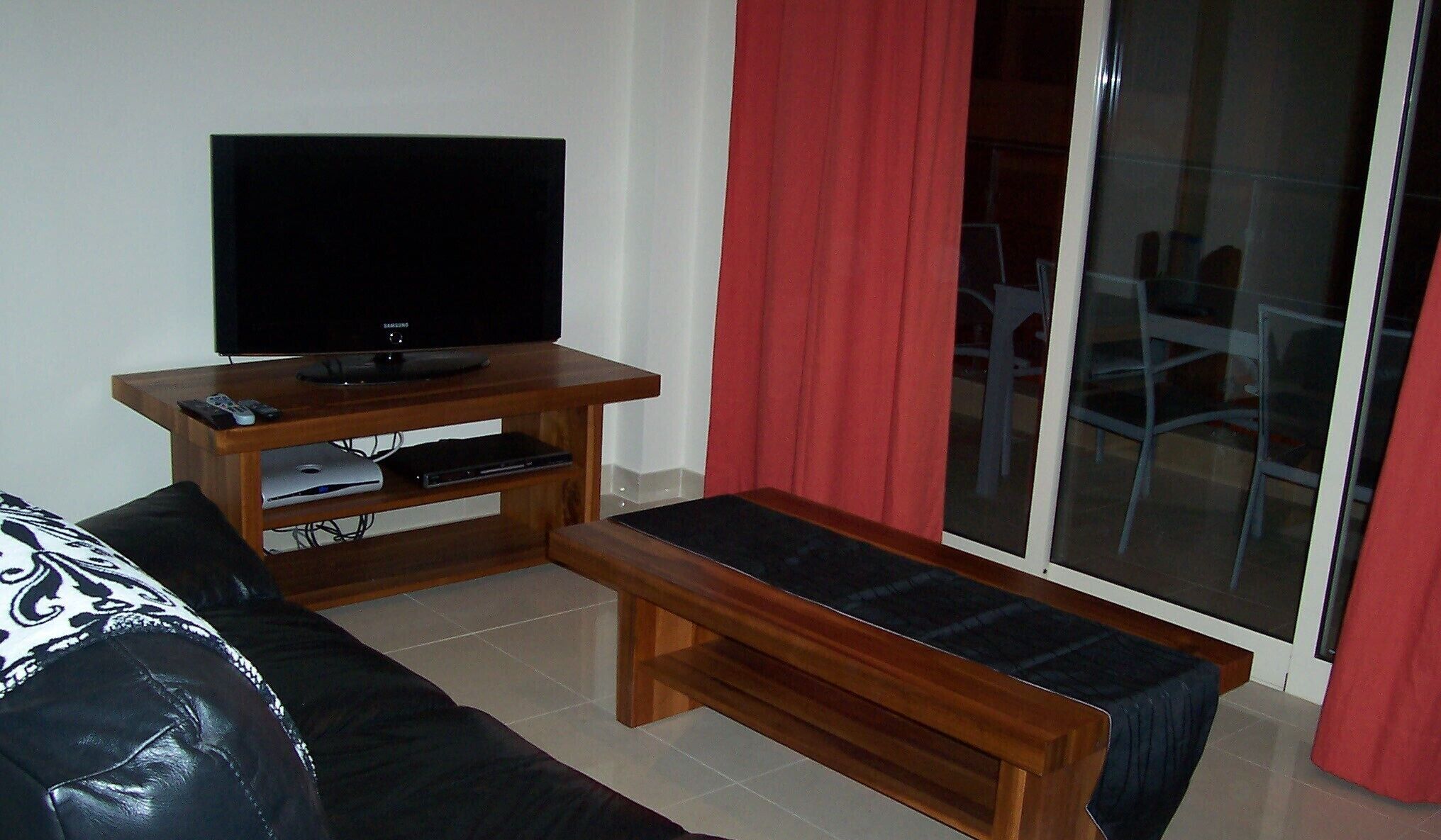 THE LIVING ROOM WITH PATIO DOOR TO THE BALCONY