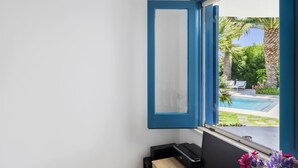 A room with a large window, a view of a swimming pool, and a door with a blue frame. - VACATION HOME 300 MT. BY THE SEA OF FINE GOLDEN SAND WITH PRIVATE POOL (Avola)