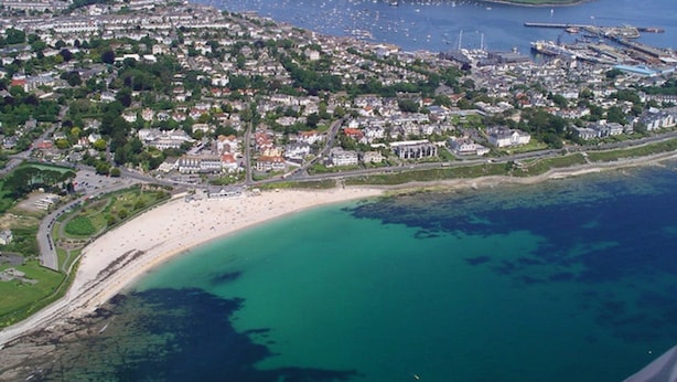An aerial view of a coastal town with a sandy beach, a marina, and residential areas. - A comfortable well located property in Falmouth with generous parking (Falmouth)