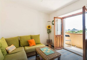 Relax in this inviting room with a sofa, coffee table, and balcony access to scenic views.
