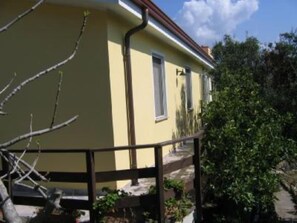 Guests can enjoy a balcony with potted plants and a tree view.