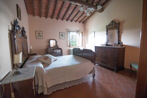 A bedroom with a bed, dresser, and a mirror.