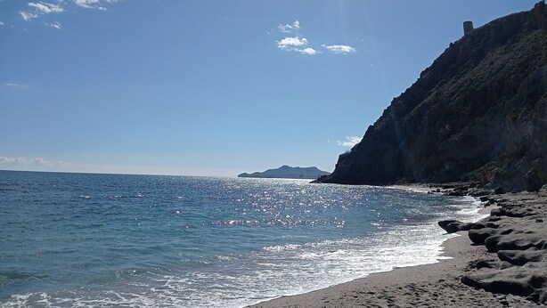 A coastal beach with clear blue water, rocky shoreline, and a distant mountain. - PENTHOUSE in Cabo de Gata with fabulous sea views (Carboneras (Almería))