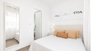 A bedroom with a bed, a nightstand, a mirror, and a door leading to a bathroom. - BEAUTIFUL HOLIDAY HOME 273 WITH PRIVATE POOL (Callao Salvaje)