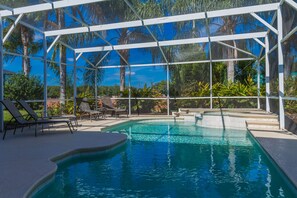 A pool area with clear blue water, surrounded by a white pergola structure, and equipped with lounge chairs. - 
Now taking bookings  for 2026 /2027 Book Now to get the best offer prices (kissimmee)