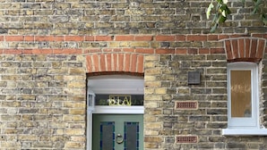 A green door with a number plate '81A' and a small window above it. - Beautiful One bedroom contemporary Interior Designed  Flat just off Kew Green (Kew Richmond)