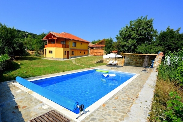The pool and house on a perfect summer's day.