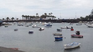 A marina with numerous boats docked. - Traditional seafront ground floor apartment. Children free in summer. (Punta Mujeres)