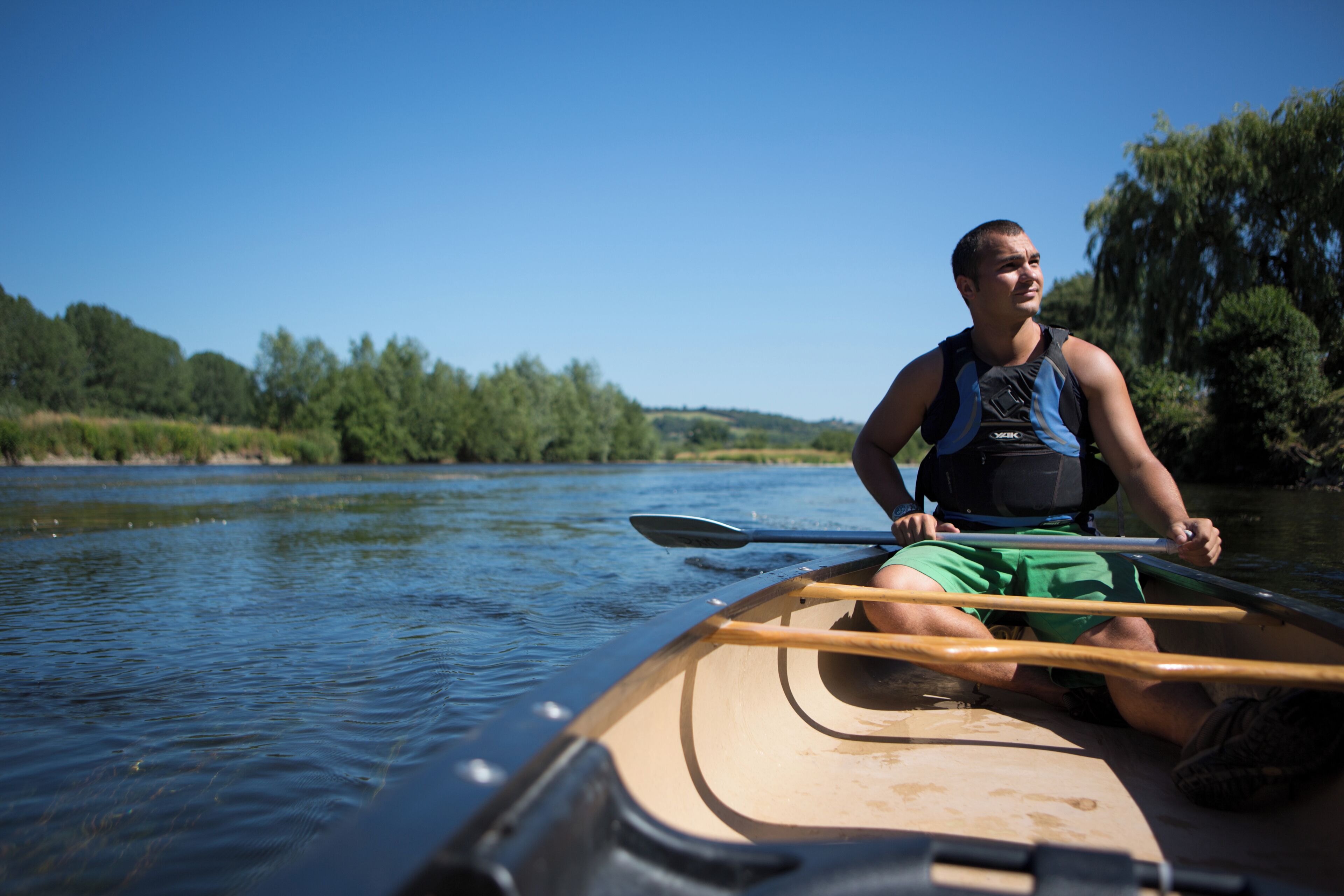 A person in a canoe on a river.