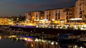 A waterfront area with buildings, boats, and a dock.
