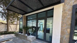 A building with stone walls, a covered entrance, and potted plants. - Sunny Residence - Luxury private property with outstanding heated pool! (Kosharitsa)