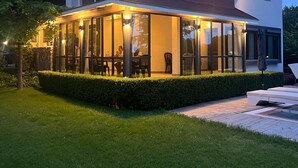 A modern two-story building with a covered patio area, large windows, and a well-maintained lawn. - Sunny Residence - Luxury private property with outstanding heated pool! (Kosharitsa)