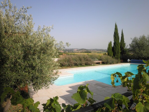 A swimming pool with a view of the countryside.