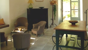 Un coin repas comprenant une table, des chaises, un vase et une fenêtre donnant sur un paysage.