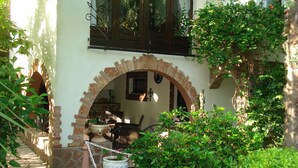 A courtyard with a brick archway, a stone pathway, and potted plants. - Villa With Private Pool And Jacuzzi (Bay of Kotor)