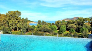 Una piscina con vistas a la playa y a los árboles.