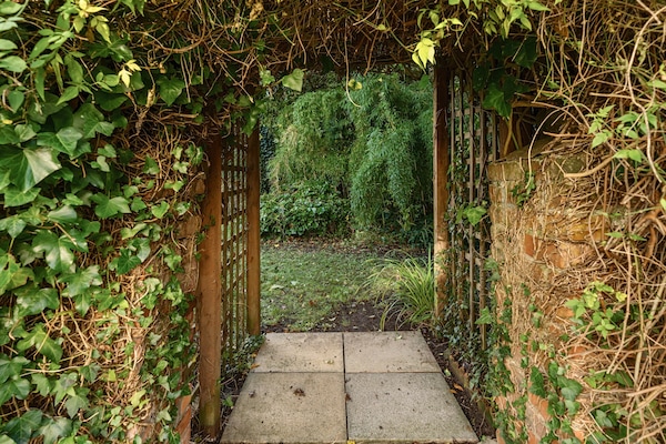 Archway leading to rear of the garden.